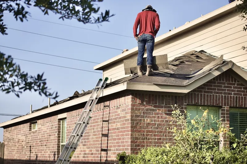 Professional roofer working on a residential roof in Dominion